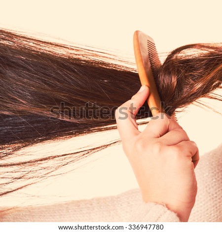 Combing with brush and pulls long hair. Daily preparation for looking nice.