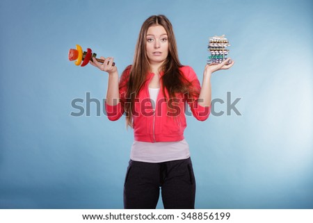 Woman girl holding diet weight loss tablets pills and vegetables. Choice between natural and synthetic way of slimming dieting. Health care.