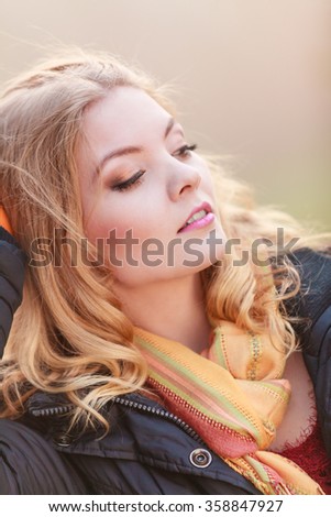 Portrait of pretty attractive fashionable woman in fall forest park. Gorgeous blonde young girl in jacket. Autumn winter fashion.