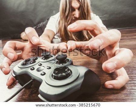 Addiction and dependency concept. Young man with pad joystick playing games. Male addicted to console playstation videogames.