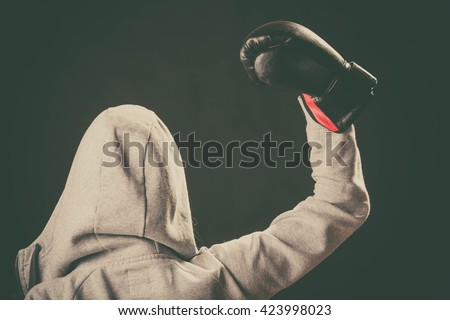 Sportsmanship and strong body. Win fight with opponent. Young woman wear hoodie victory pose show emotion with arm in air. Girl wear boxing gloves.