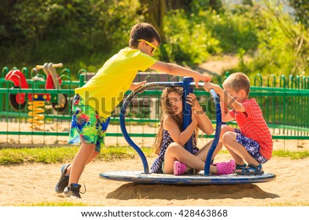 Joyful active childhood. Playful kids playing on playground. Children having fun in summer. Young tourists spending actively time.
