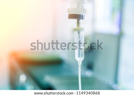 Saline iv drip fluid intravenous drop  hospital room,medical concept,treatment emergency and injection drug infusion care therapy chemotherapy, flare light background
