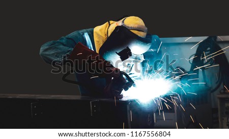 Welder is welding flux cored arc welding ,Industrial welding part in Oil and Gas or Petrochemical,Copy space