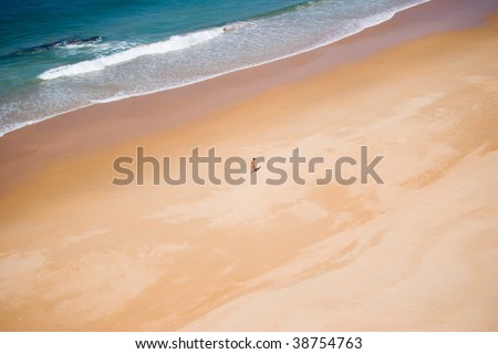 beautiful summer day beach with ocean wave and loneliness man working  on the sand
