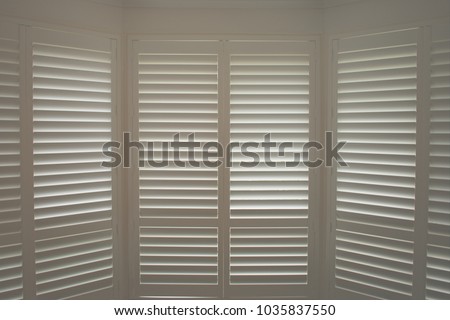 Luxury white indoor plantation shutters, closed shutters