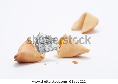 Fortune cookie broken open with miniature cash coming out