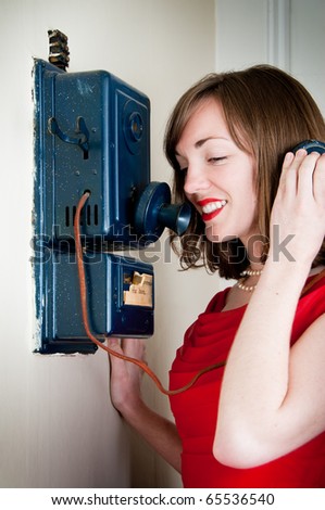 Vintage young woman talks on an antique phone