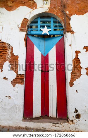 obsolete wooden door with Puerto Rican flag painted on it