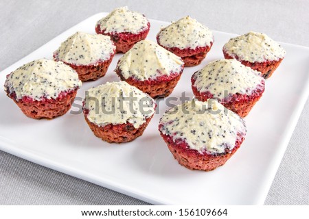 Delicious, mini sized, gluten free, red beetroot cupcakes. Butter and cream cheese topping with vanilla and poppy seeds. creative and colorful.
