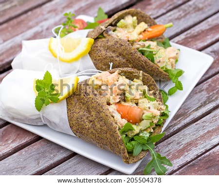 Grain free alternative wrap filled with vegetables, herbs and salmon. Served wrapped up in parchment paper.