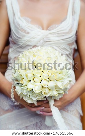 Beautiful wedding bouquet in hands of the bride.  WARNING! Focus only on the  wedding bouquet