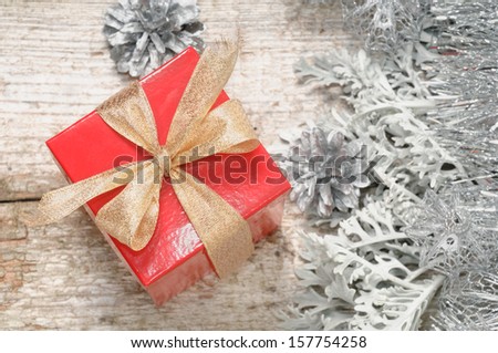 Small red box with gift for Christmas