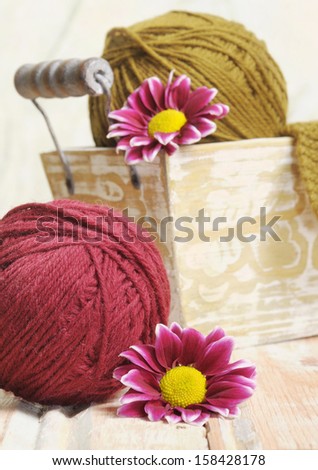 Wool clews for knitting with little burgundy flowers