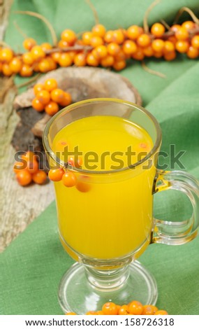 Hot fruit sea-buckthorn drink with branch of berries