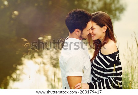 happy romantic sensual couple in love together outdoors on summer vacation