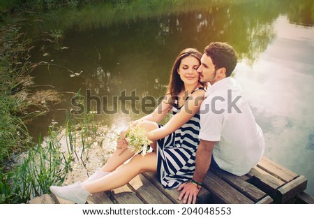 sensual romantic couple in love on pier at the lake outdoor in summer day, beauty of nature, harmony concept