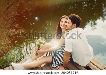 sensual romantic couple in love on pier at the lake outdoor in sunny day, beauty of nature, harmony concept
