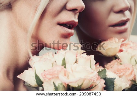 close up sensual smile woman lips in pastel color with bouquet of roses, reflection in the mirror background