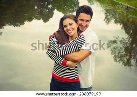 happy romantic couple in love at the lake outdoor on vacation, beauty of nature, harmony concept
