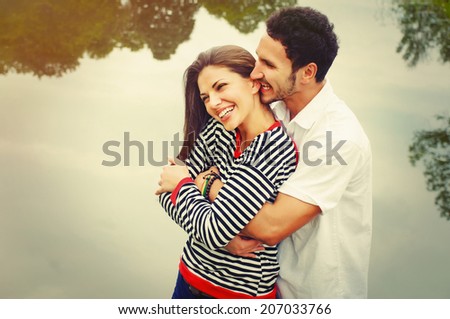 happy romantic wide smile couple in love at the lake outdoor on vacation, beauty of nature, harmony concept