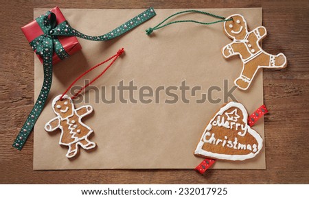 Christmas background of old paper with sweet homemade cookies and small gift, holiday concept