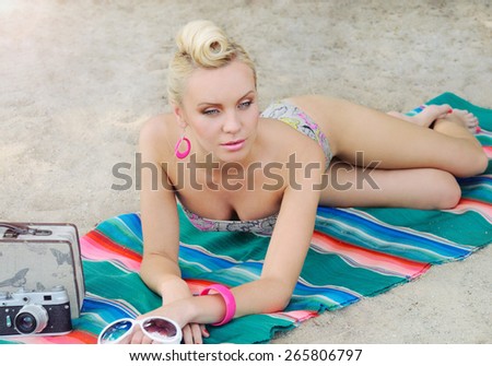 sensual hot body young woman lying on the beach with colorful details, relax concept, travel