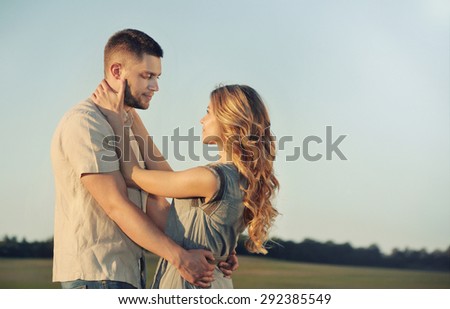 stunning sensual young couple in love posing in summer field, happy lifestyle concept