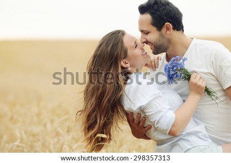 stunning sensual young couple in love posing in summer field, happy lifestyle concept