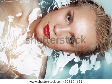 fashion portrait of attractive woman in water, fashion beauty concept