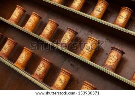 Detail of ancient drug store (pharmacy) with wooden containers on shelves.