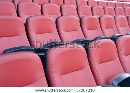 Multiple seats in row on football stadium.