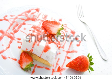 Delicious strawberry cream cake with fresh strawberries and decoration.