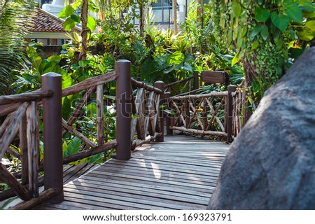 Wood path walkway in deep tropical forest