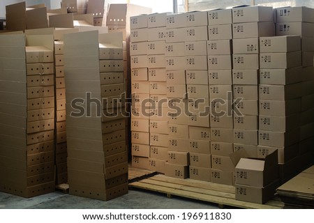 group of stacked cardboard boxes on wooden pallets  in factory warehouse