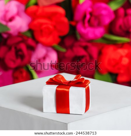 a gift for the holiday, white box with a red bow. Valentines Day, Christmas, birthday or Mothers Day
