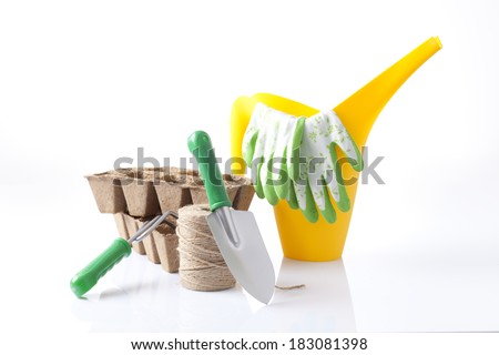 watering can and garden tools isolated on white