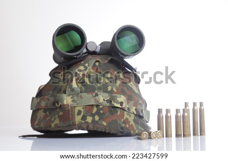 Bullets and military helmet and binoculars isolated on a white background