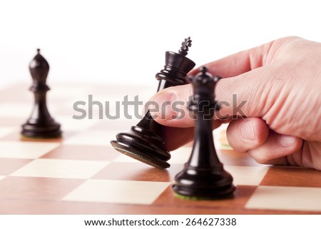 Playing chess - hand moving black king