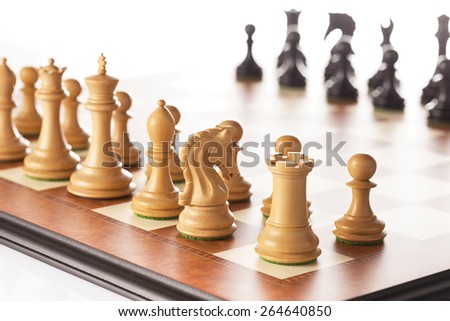Chess setup - black and white chess pieces standing on a chessboard