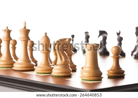 White chess pieces standing on a chessboard before the chess game