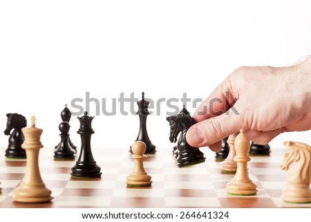 Chess game - black knight captures a white pawn during the middle game