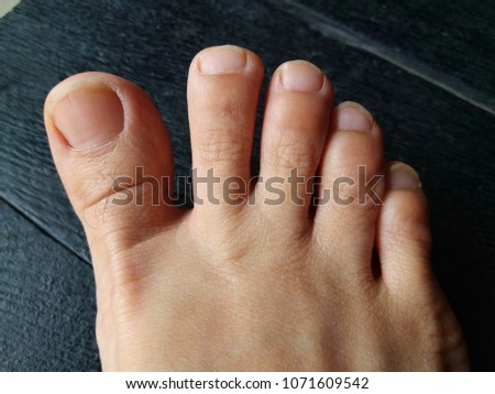 bare foot, asian woman foot on black wooden floor