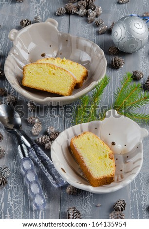 Place setting for Christmas with Christmas cake on a wooden table