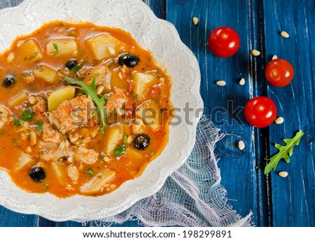 Fish soup with cod, potatoes, tomatoes and black olives