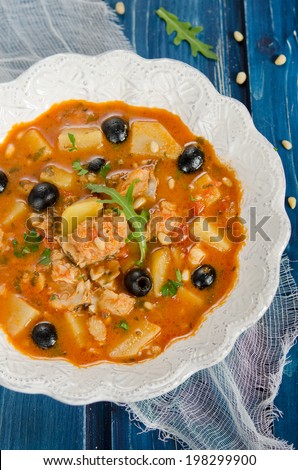 Fish soup with cod, potatoes, tomatoes and black olives