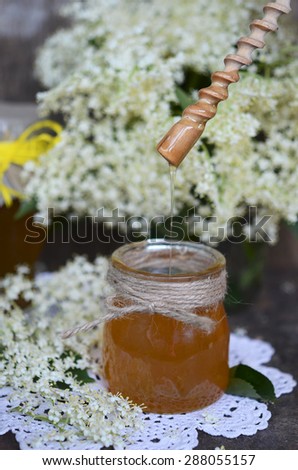 Elderflower honey in jar, made out of fresh elderflower blossoms mixed with sugar