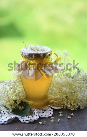 Elderflower honey in jar, made out of fresh elderflower blossoms mixed with sugar