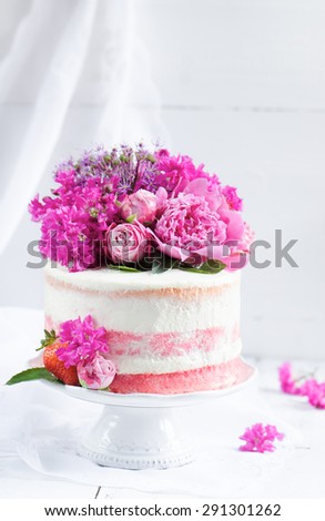 Strawberry cake with floral decoration on a white background