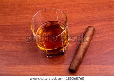 whiskey and cigar on the wooden table